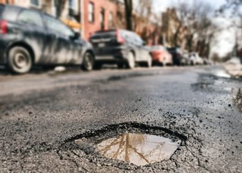 Why should NYS exempt itself from liability if a motorist goes over a pothole and car is damaged?